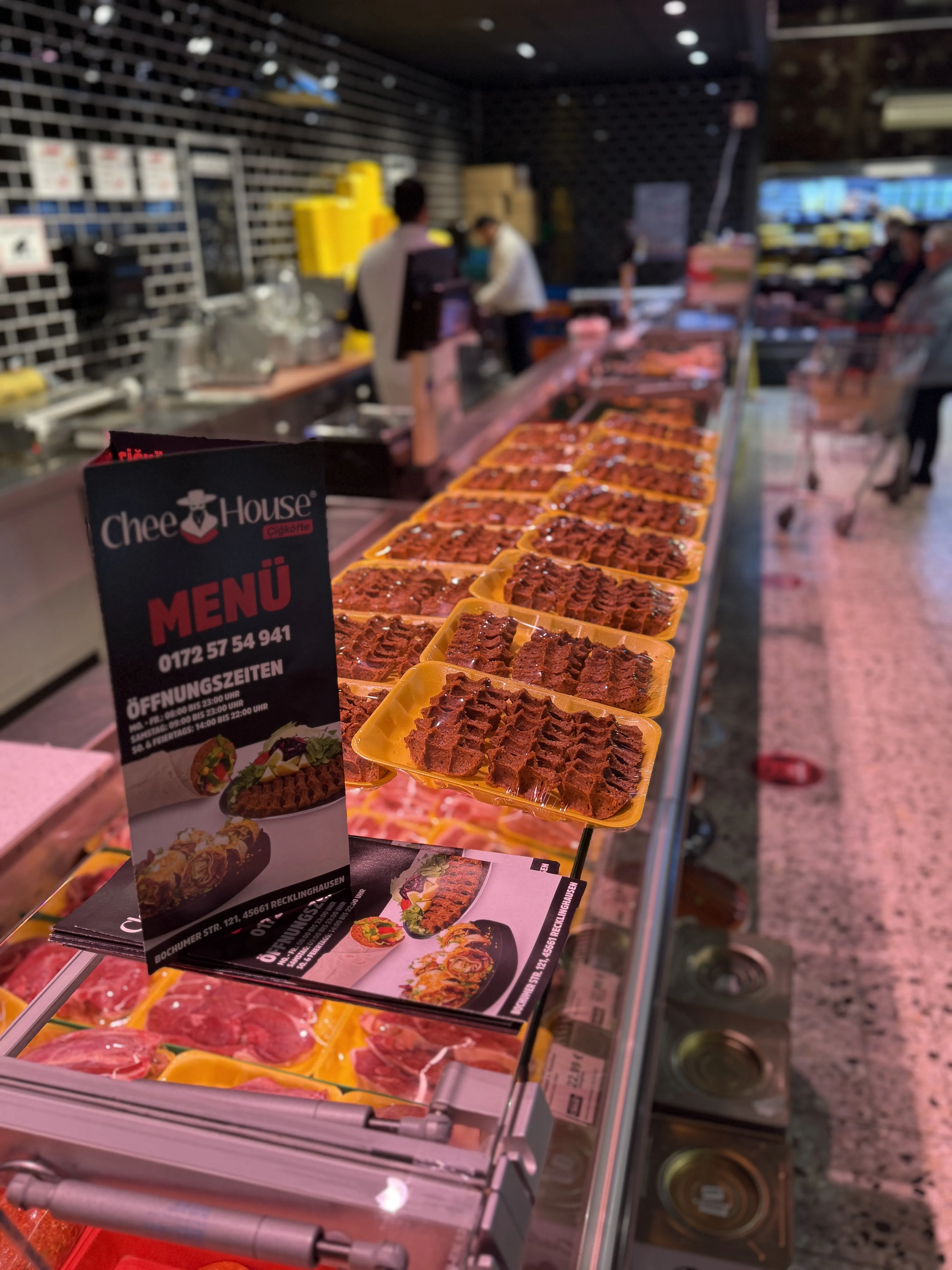Verkaufstheke mit frischen Çiğköfte-Portionen und Chee House Menü